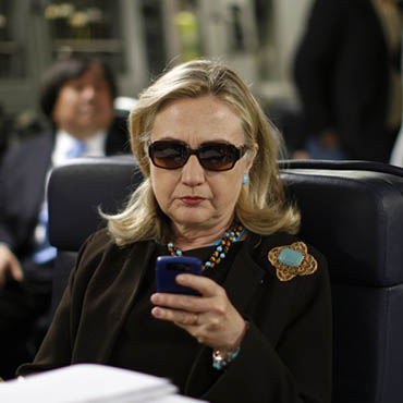 Associated Press image (by Kevin Lamarque): Hillary Clinton on a plane to Libya.