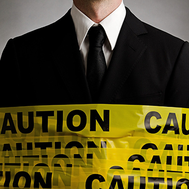 Shutterstock image: manager wrapped in caution tape.
